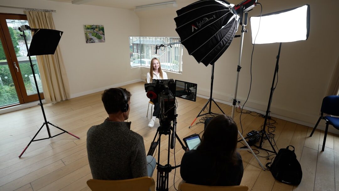 Camera crew filming in a TV studio with professional broadcast equipment