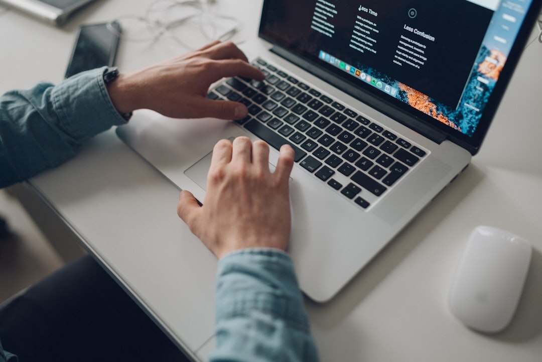 Developer coding editorial management software on laptop
